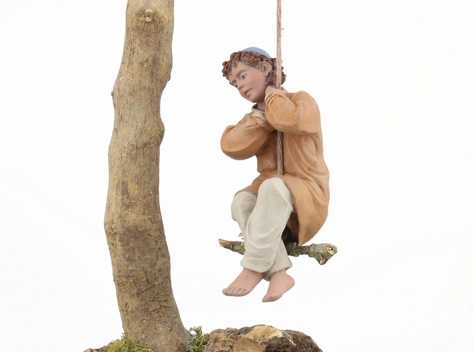 Niño columpiándose 20 cm.