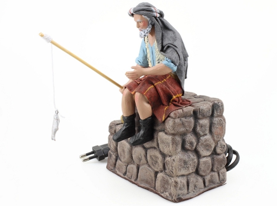 Pescador sobre piedras 17 cm. (movimiento)